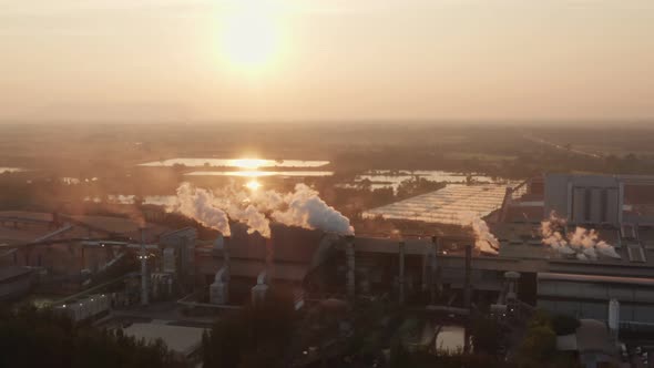 Aerial view Drone shot of flying around toxic chimneys tubing. Air Pollutants, Industrial zone