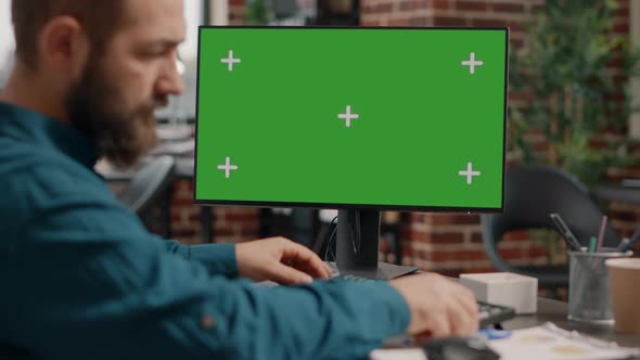 Close Up of Man Working on Horizontal Green Screen at Desk