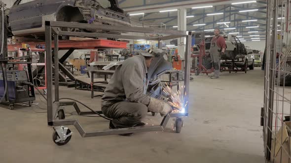 Welder Works, Worker Works In The Auto Workshop