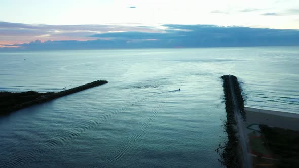 Lone boat ventures out at sunrise, Gold Coast Seaway, blue hour, Dawn