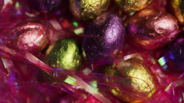 Rotating shot of colorful Easter candies on a bed of easter grass 