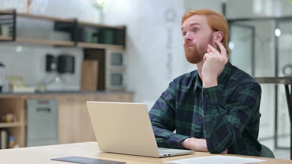 Beard Redhead Man with Laptop Thinking and Getting Idea 