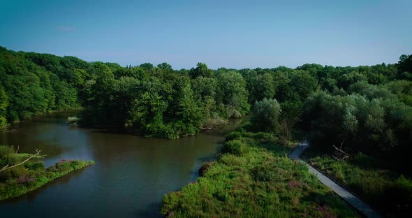 Aerial footage of wetlands with a boardwalk and river throughout.