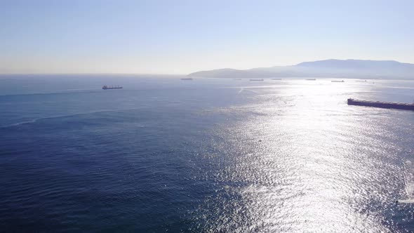 Aerial Pan Left View Of The Strait Of Gibraltar With Ships In Background. Establishing Shot