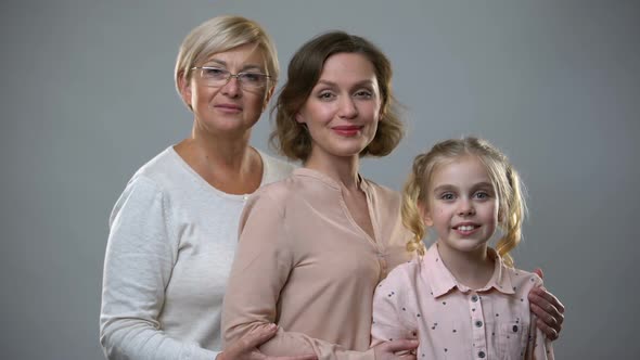 Smiling Multigeneration Females on Grey Background, Family Connection, Love