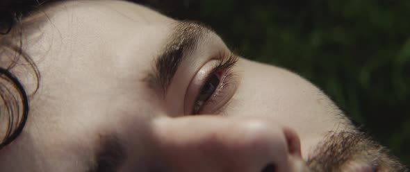 Man lying down on the grass and looking up