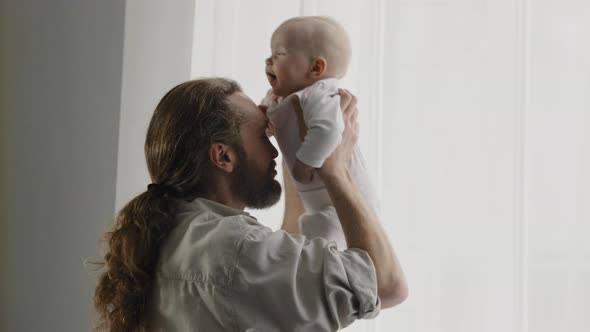 Caucasian Family Bearded Father Daddy Dad Play with Little Daughter Son Baby Infant Newborn Toddler