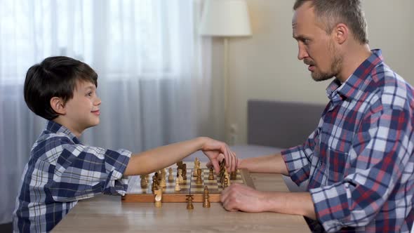 Male Kid Winning Chess With His Father, Little Son Shaking Hand With Dad, Hobby