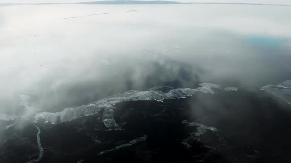 It's an Aerial View. The Rapid Movement of the Camera Over the Newly Frozen River. The Ice Is Smooth