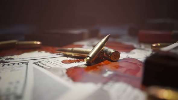 Few bullets lying on the table filled with dollar bills stained with blood. 4KHD