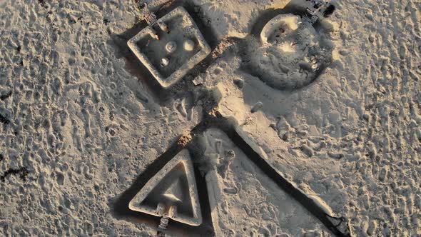 Aerial, top down, drone shot, rising above drawing in sand