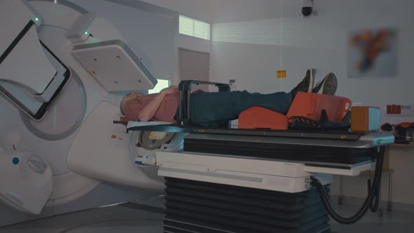 Patient Getting Radiation Therapy Treatment Inside A Modern Radiotherapy Room