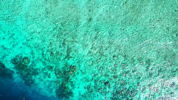 Wide aerial abstract shot of a white sand paradise beach and blue ocean background in hi res 4K