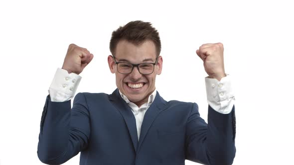 Successful Happy Businessman in Glasses and Blue Suit Rejoicing Winning and Shouting for Joy and