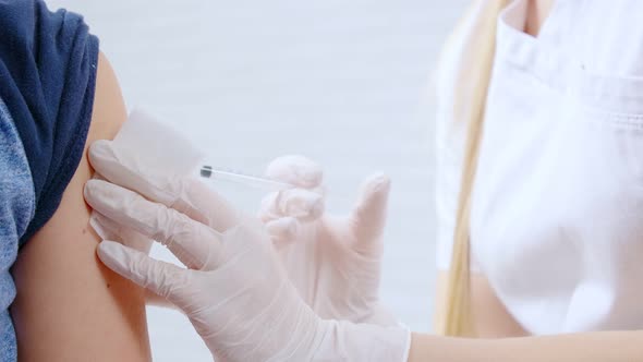 Nurse in Uniform and Rubber Gloves Making Injection for Boy