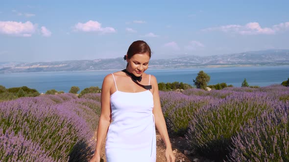 Woman Walking on Lavender Field