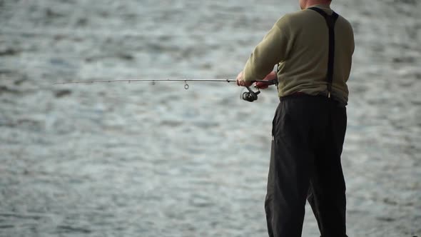 Man Hobby Fishing on Sea Tightens a Fishing Line Reel of Fish Summer