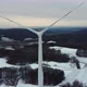 Flying above a wind turbine. Wind power plant in a winter landscape. - VideoHive Item for Sale