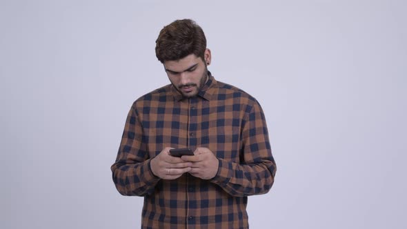 Happy Young Bearded Indian Hipster Man Using Phone