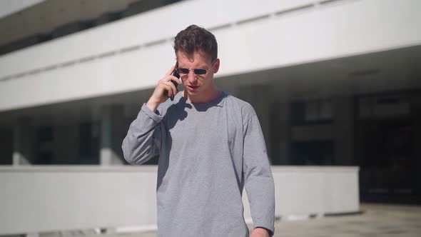 Handsome Angry Man Talking on Phone and Yelling Other Person with Anger