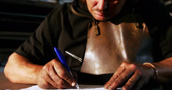 Welder working on blueprint