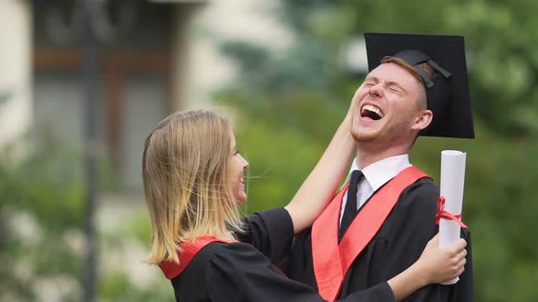 Tender Female Graduate Joking and Laughing With Boyfriend, Celebrating Success