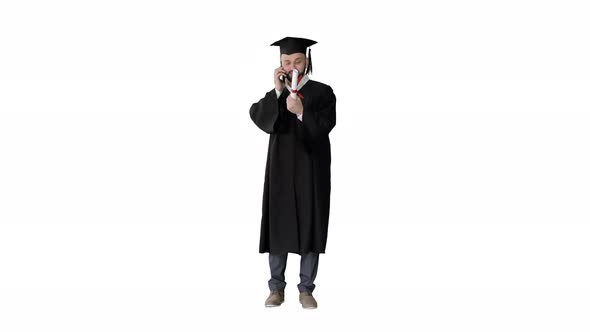 Happy Graduated Young Man in Cap and Gown Talking with Parent on Mobile Phone on White Background