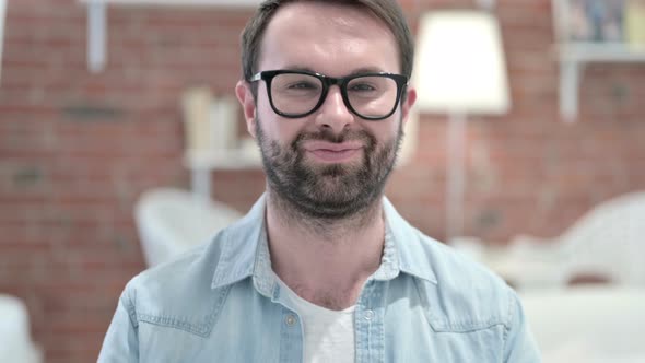 Portrait of Beard Young Man Saying Yes with Head Shake 