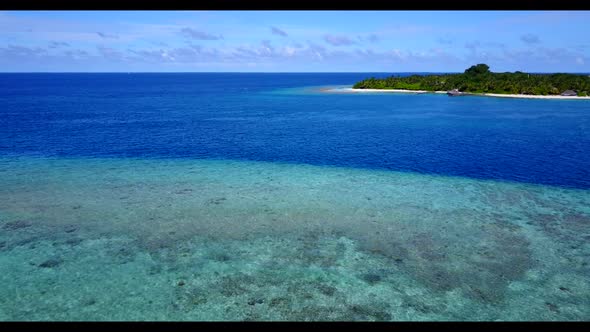 Aerial panorama of marine tourist beach vacation by aqua blue ocean with white sand background of a 