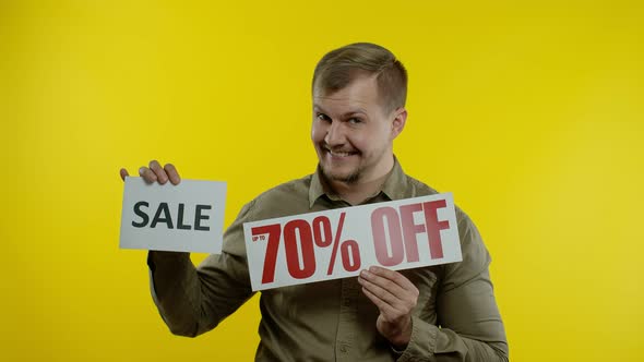 Joyful Man Showing Sale Word and Showing Up To 70 Percent Off Inscription, Black Friday Concept