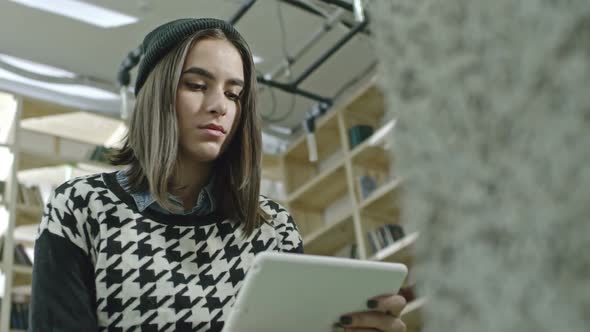 Hipster Girl Sitting in Office with Tablet