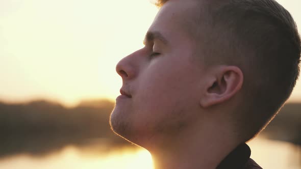 Close Up of Pensive Handsome Smiling Face Young Man Enjoying Nature Summer Adventure