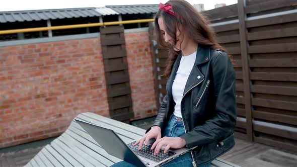 Young Female Student Working Outside