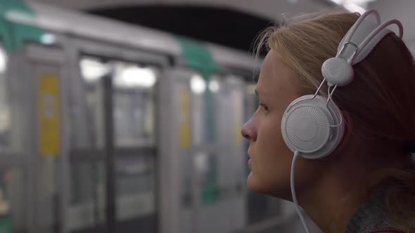 Woman Listening To Music in Subway