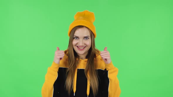 Portrait of Modern Girl in Yellow Hat Is Showing Thumbs Up, Gesture Like