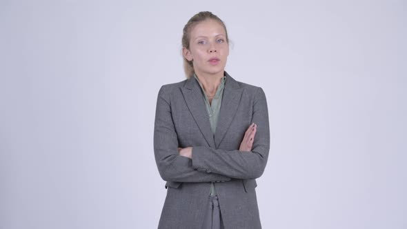 Young Angry Blonde Businesswoman with Arms Crossed