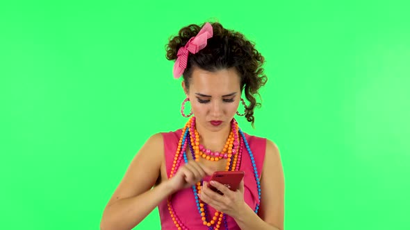 Young Woman Angrily Texting on Her Phone on Green Screen