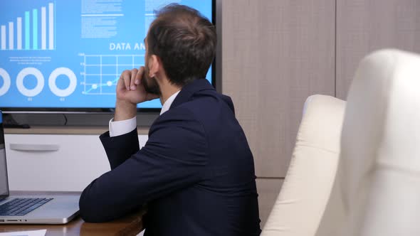 Revealing Shot of Businessman Working on the Computer