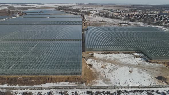 Flying Over Glass Greenhouses Growing Plants View From a Height Reflections in Glass Surfaces