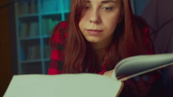 A Beautiful Student Reading a Big Book