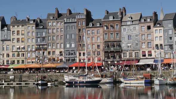 HONFLEUR, FRANCE - SEPTEMBER 2016 Panning on world famous The Vieux Bassin port  by the day with col
