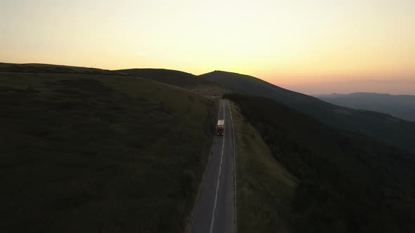 Cargo Truck with Trailer Going Down Sunset Mountain Pass