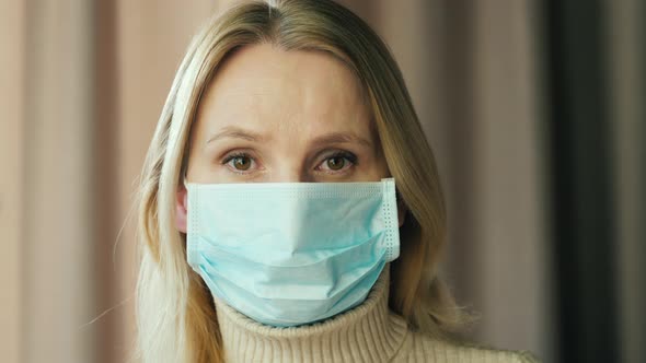 Portrait of a Sad Woman in a Gauze Bandage, Quarantine Concept