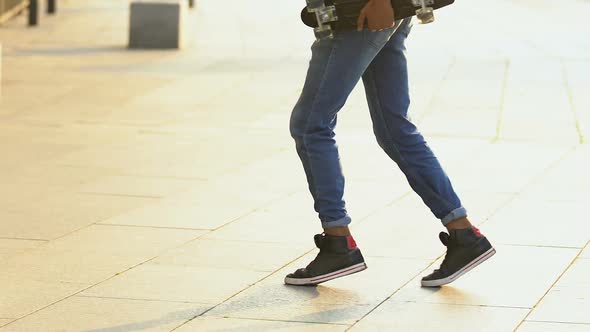 Teenage Boy With Skateboard Dancing Outside, Having Fun, Street Performance