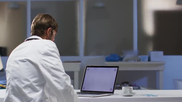 Caucasian male doctor having video call consultation using laptop