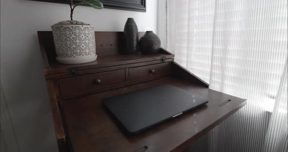 Modern home office with fig plant, decor and mirror with slow and smooth camera push in.