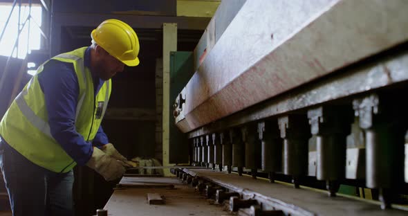 Male worker working on machine in warehouse 4k