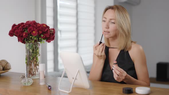 Beautiful Young Woman Applies Makeup