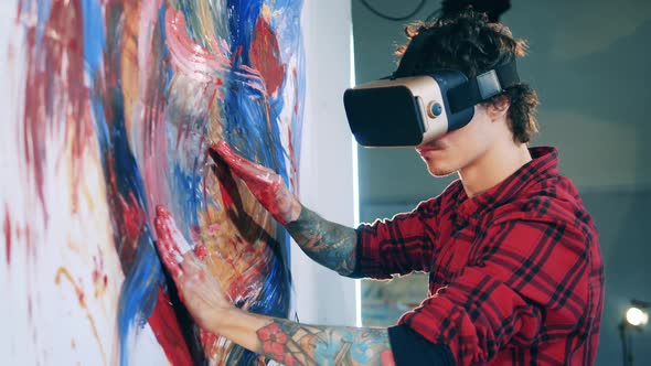 An Artist in VRglasses is Painting a Colourful Picture