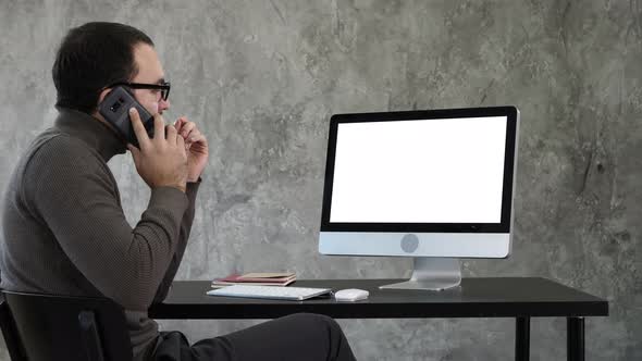 Male Designer Working At Computer In Contemporary Office